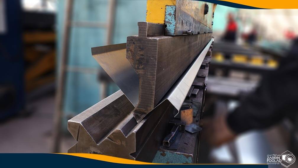 اپراتور در حال خم کردن آبرو گالوانیزه به کمک دستگاه پرس برک است.